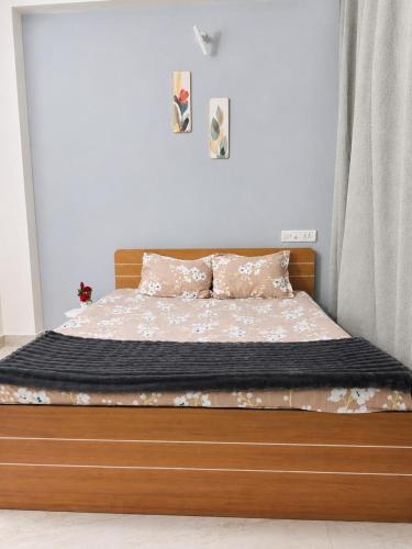 a bed with a wooden frame in a bedroom at SV Serenity Homestays in Gachibowli