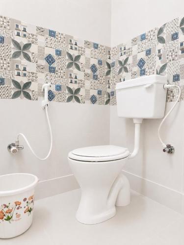 a bathroom with a toilet and a bath tub at SV Serenity Homestays in Gachibowli