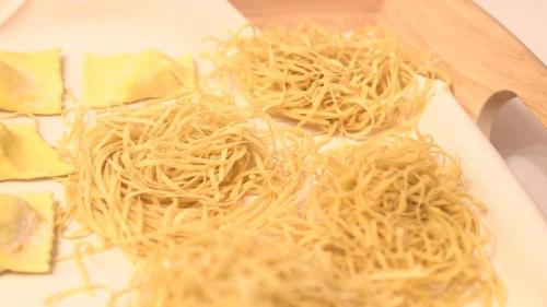 a plate of noodles and cheese on a table at Hotel Ristorante La Grotta in Castiglione delle Stiviere