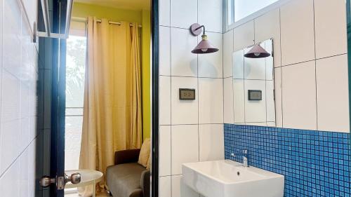 a bathroom with a sink and a mirror at Halo Bonjour Perch in Ban Chuang