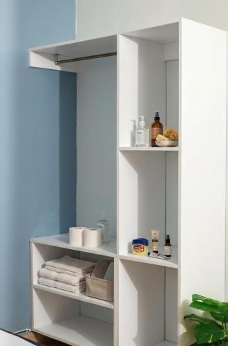 a white shelf in a bathroom with towels at Reenhomes in Kilifi