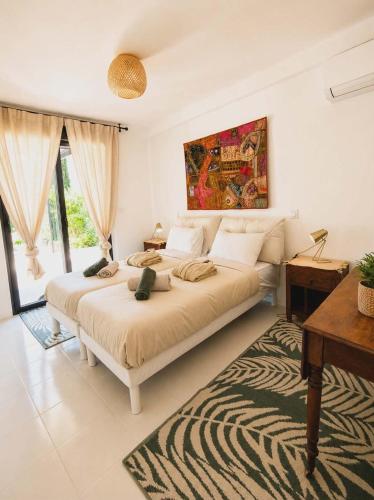 a bedroom with a large bed and a desk at La Maison du Bonheur in Saint-Raphaël