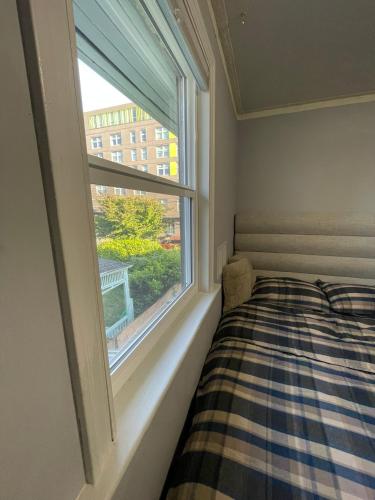 a bedroom with a bed and a window at Vancouver east downtown queen bed room share bathroom in Vancouver