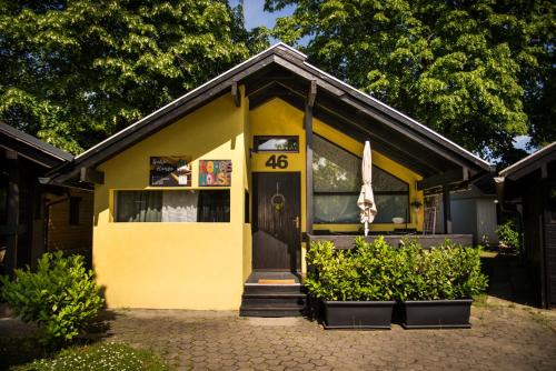 a yellow house with the number on it at Boho House 5 camp Terme Catez with promotional tickets prices in Čatež ob Savi