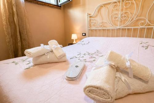 a bedroom with a white bed with towels on it at Apartment between Pisa Lucca and Florence in Cascina