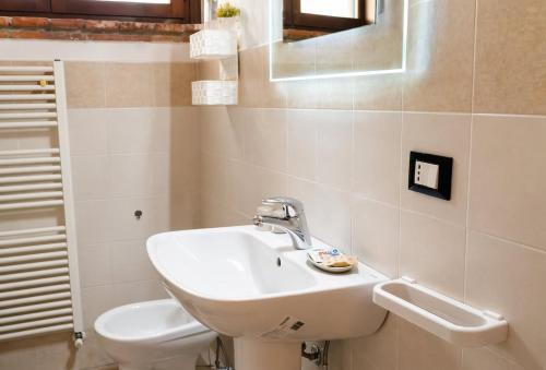 a bathroom with a sink and a toilet at Apartment between Pisa Lucca and Florence in Cascina