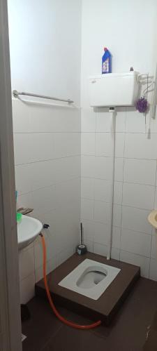 a bathroom with a toilet and a sink at Aisyhome in Jitra