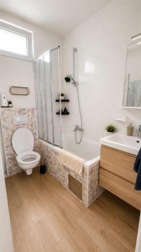 a bathroom with a shower and a toilet and a sink at Family nest Medulin- apartment with private parking and jacuzzi in Medulin