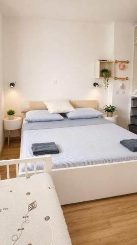 a bedroom with a large white bed in a room at Family nest Medulin- apartment with private parking and jacuzzi in Medulin