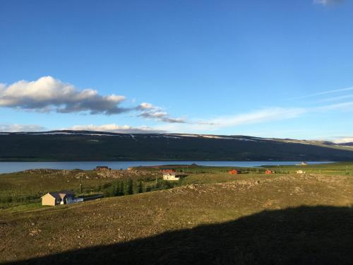 a view of a hill with a body of water at Aurora Vacation Homes Fagravik in Akureyri