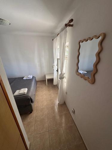 a bedroom with a bed and a mirror on the wall at Casa Julia in Herceg-Novi