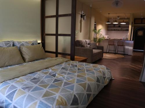 a bedroom with a bed and a living room at Smile Home in Hanoi