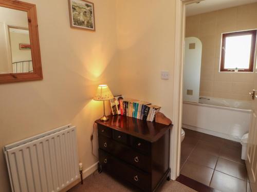 a bathroom with a dresser with a lamp on it at Valley View in Cleator Moor