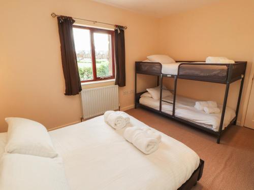 two bunk beds in a room with a window at Valley View in Cleator Moor
