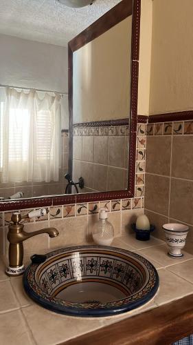 a bathroom sink with a large mirror above it at Casa La Ferrata in Jimera de Líbar