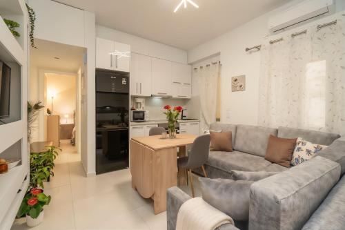 a living room with a couch and a table at Comfy Apt next to metro in Athens