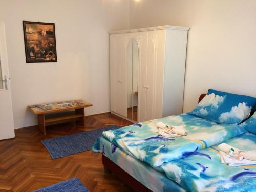 a small bedroom with a bed and a table at Írisz Apartman Budapest in Budapest