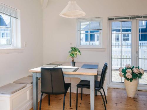 a dining room with a table and chairs at 4 star holiday home in Ringkøbing in Ringkøbing