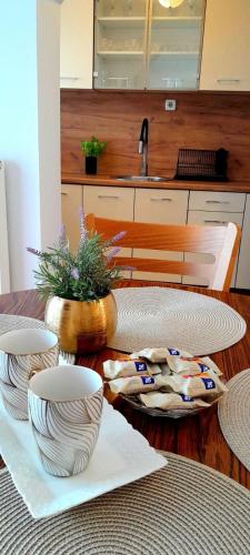 a table with three bowls on top of it at Apartman Layla in Bihać