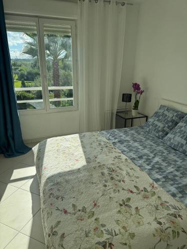 a bedroom with a large bed and a window at wonderful sea view in Antibes