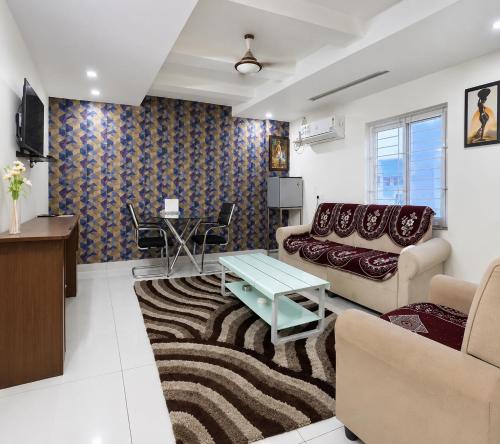 a living room with a couch and a table at The EMBASSY HOTEL in Guntūr