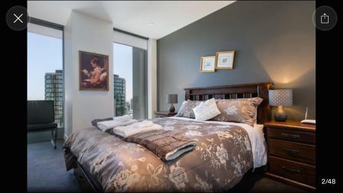 a bedroom with a large bed and a desk and window at Fantastic Freshwater in Melbourne