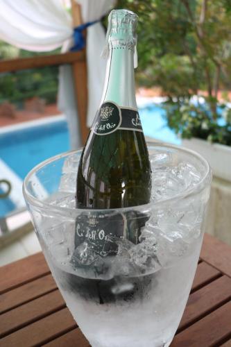 a bottle of wine sitting in a bowl of ice at Orchidea Hotel in Tirana