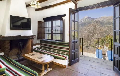a room with a fireplace and a door with a view at Casa Rural La Albahaca in Jimera de Líbar