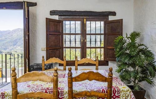 a bedroom with a bed and a large window at Casa Rural La Albahaca in Jimera de Líbar