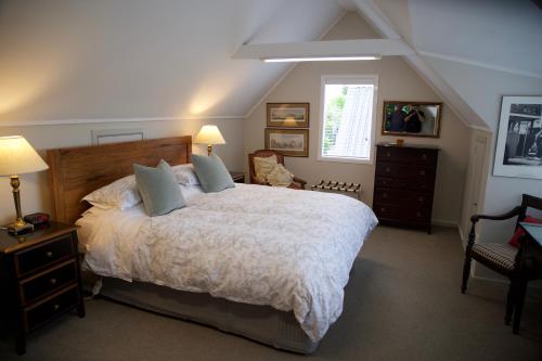 a bedroom with a large bed and a window at Sunny Glen Cottage in Waikanae