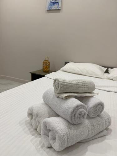 a pile of towels sitting on top of a bed at Sherpa space in Almaty
