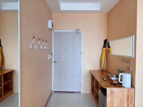 a bathroom with a shower with a glass door at De Mer Resort Rayong in Ban Ao Makham Pom