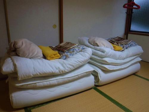 Letto o letti in una camera di Wholeearth Ryokan Hiroshima