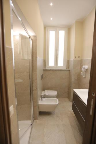 a bathroom with a toilet and a sink and a shower at Palazzo Campisi rooms in Tropea