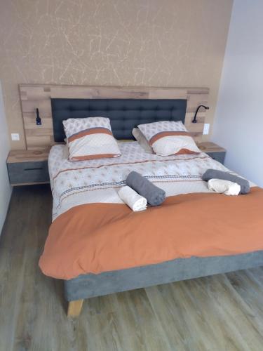 a large bed with two pillows on top of it at L'Escale Baie in Pendé