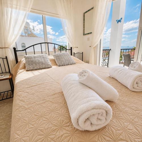 a bedroom with two beds with towels on them at Villa Athena in Peyia