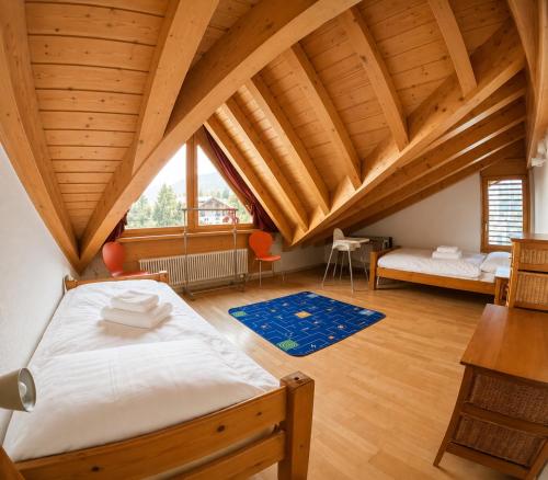 a large room with a bed in a attic at Residenz Darianne Leukerbad in Leukerbad