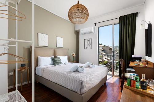 a bedroom with a bed and a balcony at The Square Hotel by X&N in Athens