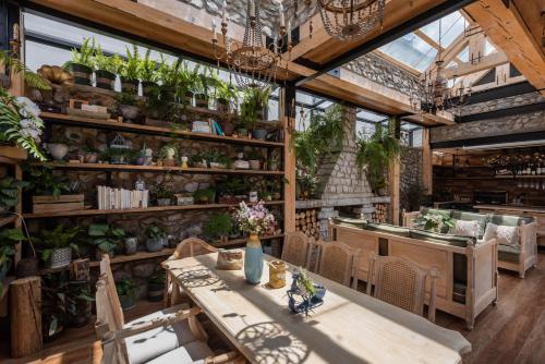 a greenhouse with a table and chairs and plants at Dali GuGu Hotel in Dali Ancient Town