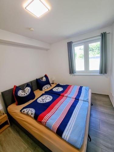 a bedroom with a large bed with pillows on it at Ferienwohnung Müller in Zirkow