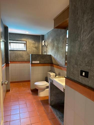 a bathroom with a toilet and a sink at See Through Resort Haad Yao in Haad Yao