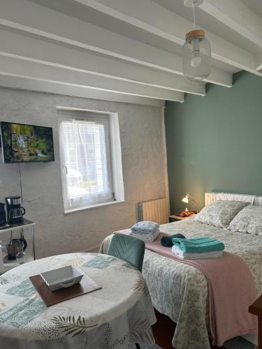 a bedroom with two beds and a window at La Maisonnette in Cellettes