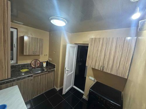 a small kitchen with a sink and a white door at Davitis Vila in Chakvi