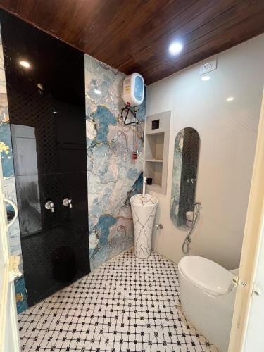 a bathroom with a shower and a toilet in it at Hyton Grand - Kilambakkam in Urapakkam