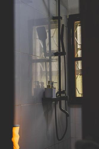 a bathroom with a shower head on a wall at JOSIRE Residence in Entebbe