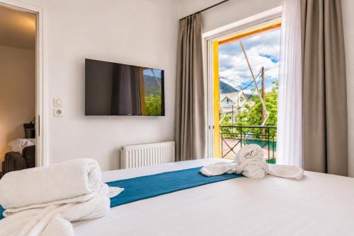 a bedroom with a bed with towels on it at Pelagos Suites in Igoumenitsa