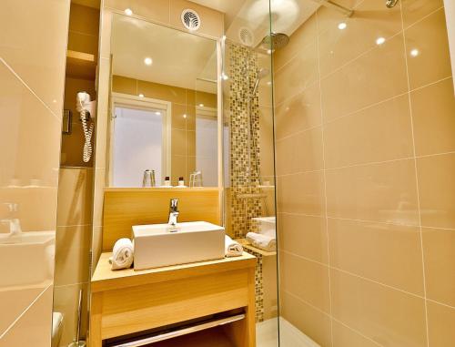 a bathroom with a sink and a shower at Le Petit Prince in Sainte-Maxime
