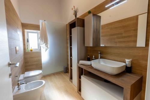 a bathroom with a sink and a toilet at Sweet Nonna Dora Corato - Casa con Parcheggio in Corato