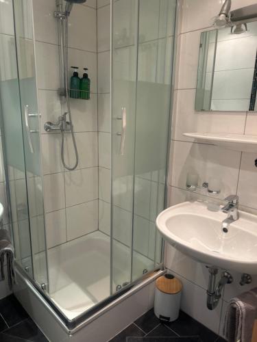 a shower with a glass door next to a sink at Bella Vista in See