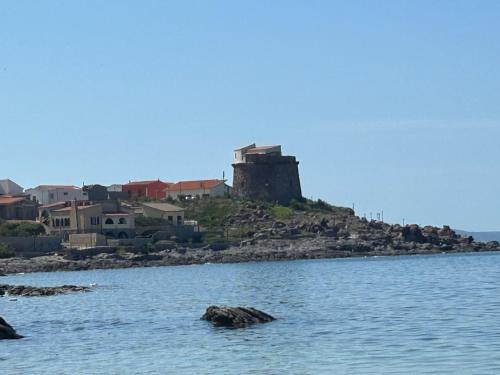 a castle on an island in a body of water at casa vacanze AG in Portoscuso